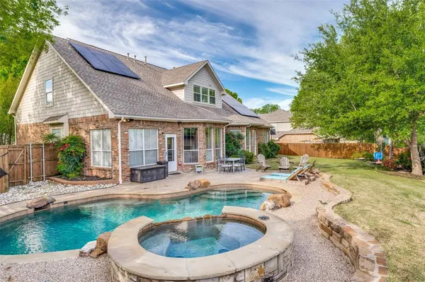 a swimming pool with outdoor seating yard and patio