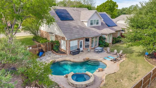 a view of house with backyard and outdoor seating