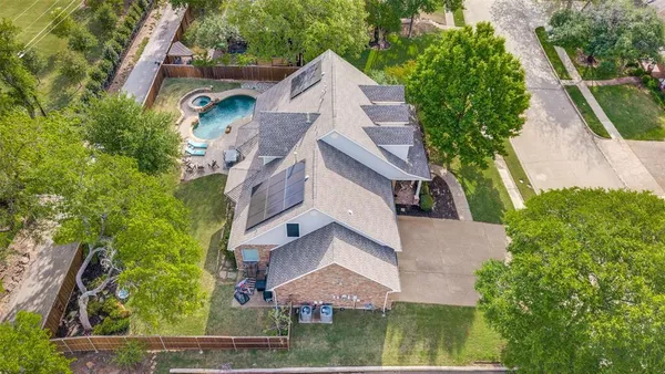 an aerial view of house with yard and outdoor seating