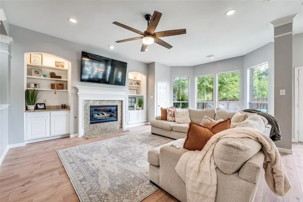 a living room with furniture fireplace and a flat screen tv