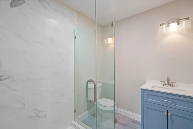 a bathroom with a toilet a sink and shower