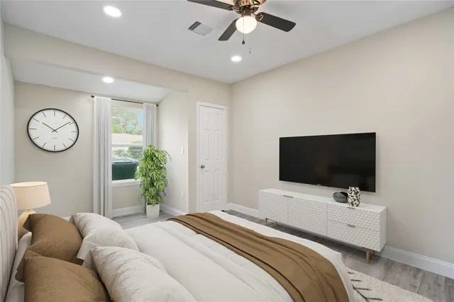 a bedroom with a bed and a flat screen tv