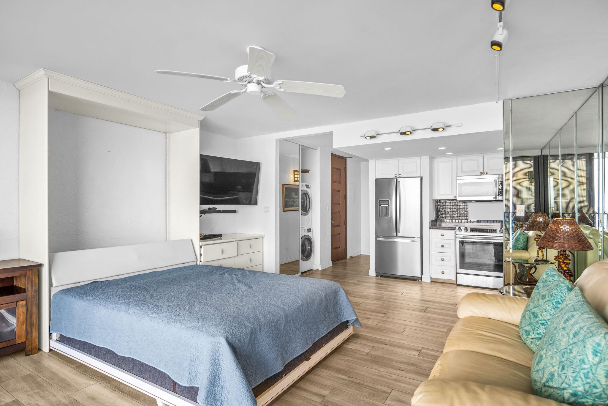 3543 Lower Honoapiilani Road, Unit F303 Lahaina, HI 96761 - Photo 13 of 20 a spacious bedroom with a bed and a flat screen tv