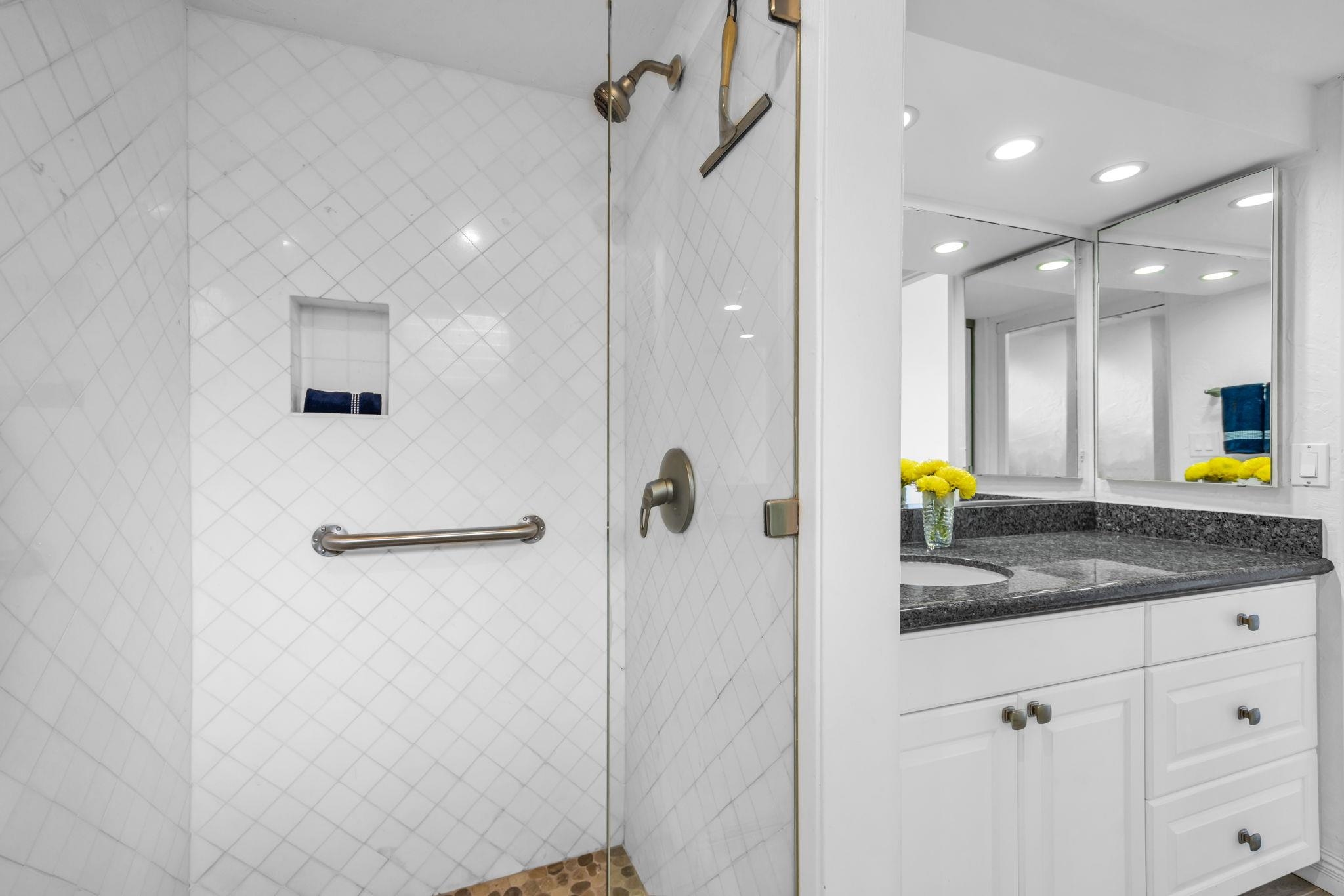 3543 Lower Honoapiilani Road, Unit F303 Lahaina, HI 96761 - Photo 16 of 20 a bathroom with a granite countertop sink a mirror and shower