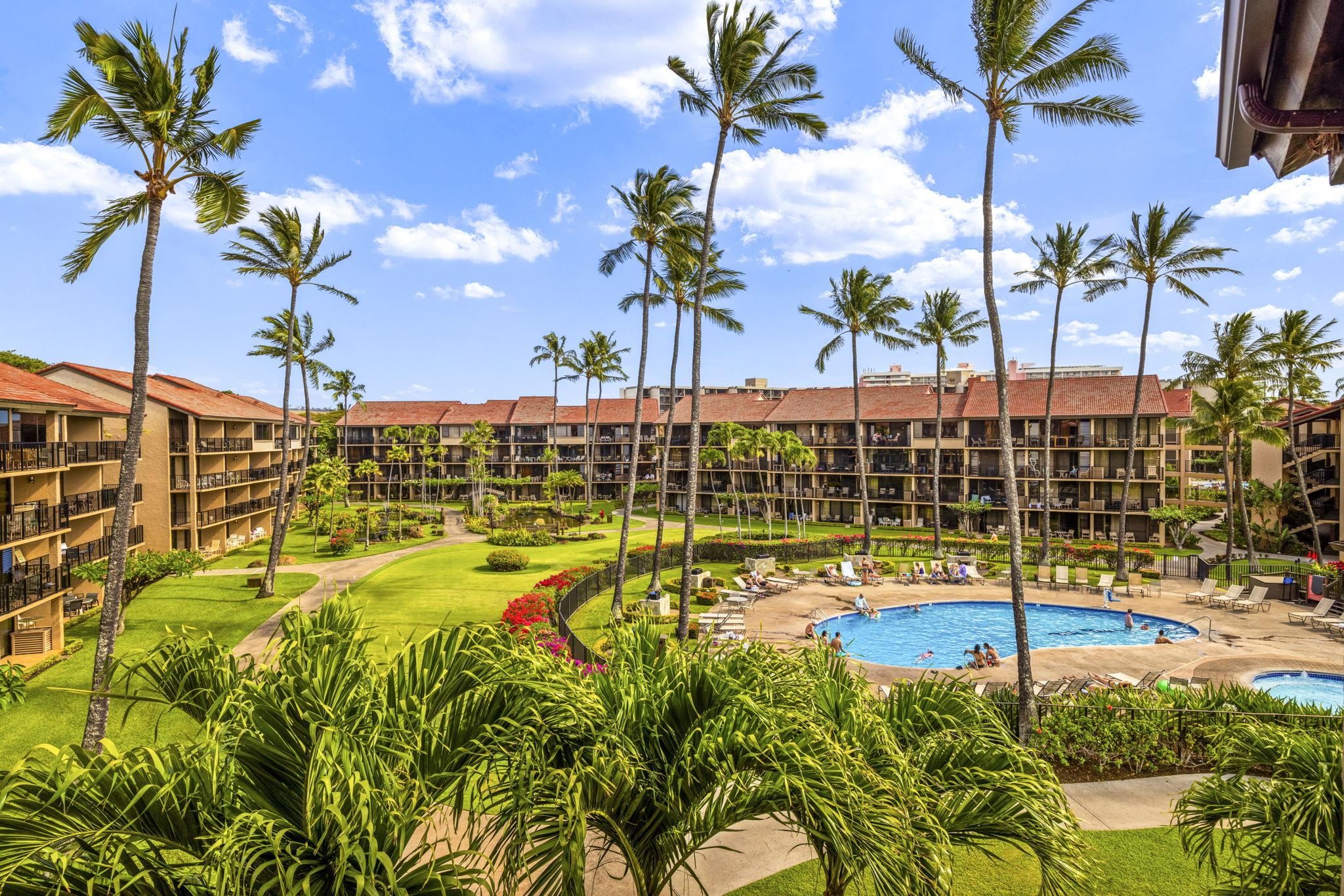 3543 Lower Honoapiilani Road, Unit F303 Lahaina, HI 96761 - Photo 19 of 20 a view of a swimming pool with a lawn chairs under an umbrella