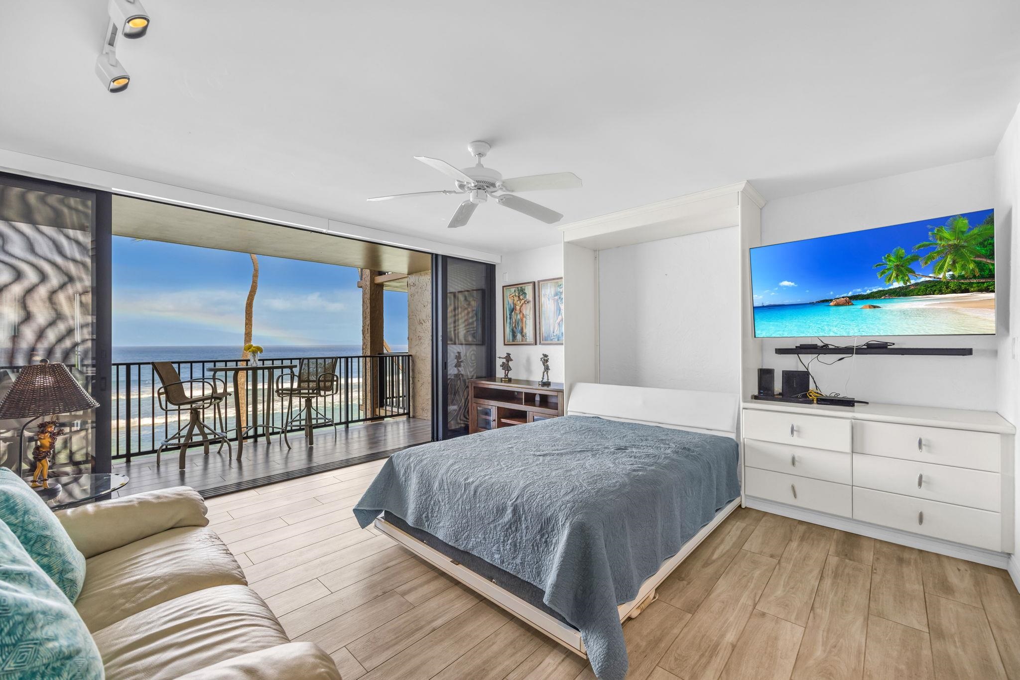 3543 Lower Honoapiilani Road, Unit F303 Lahaina, HI 96761 - Photo 2 of 20 a bedroom with a large bed and a flat tv screen on dresser
