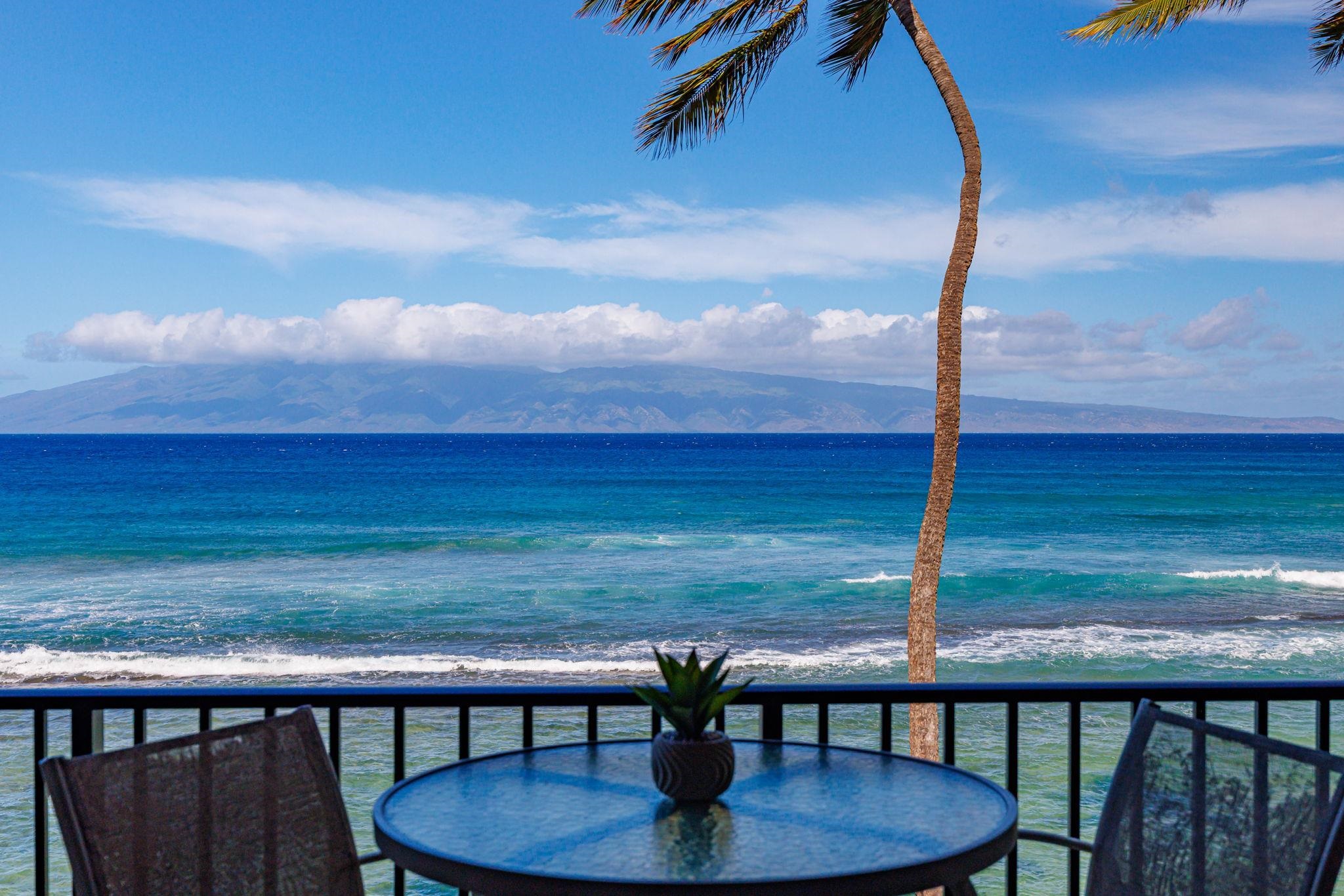3543 Lower Honoapiilani Road, Unit F303 Lahaina, HI 96761 - Photo 6 of 20 a balcony with table and chairs