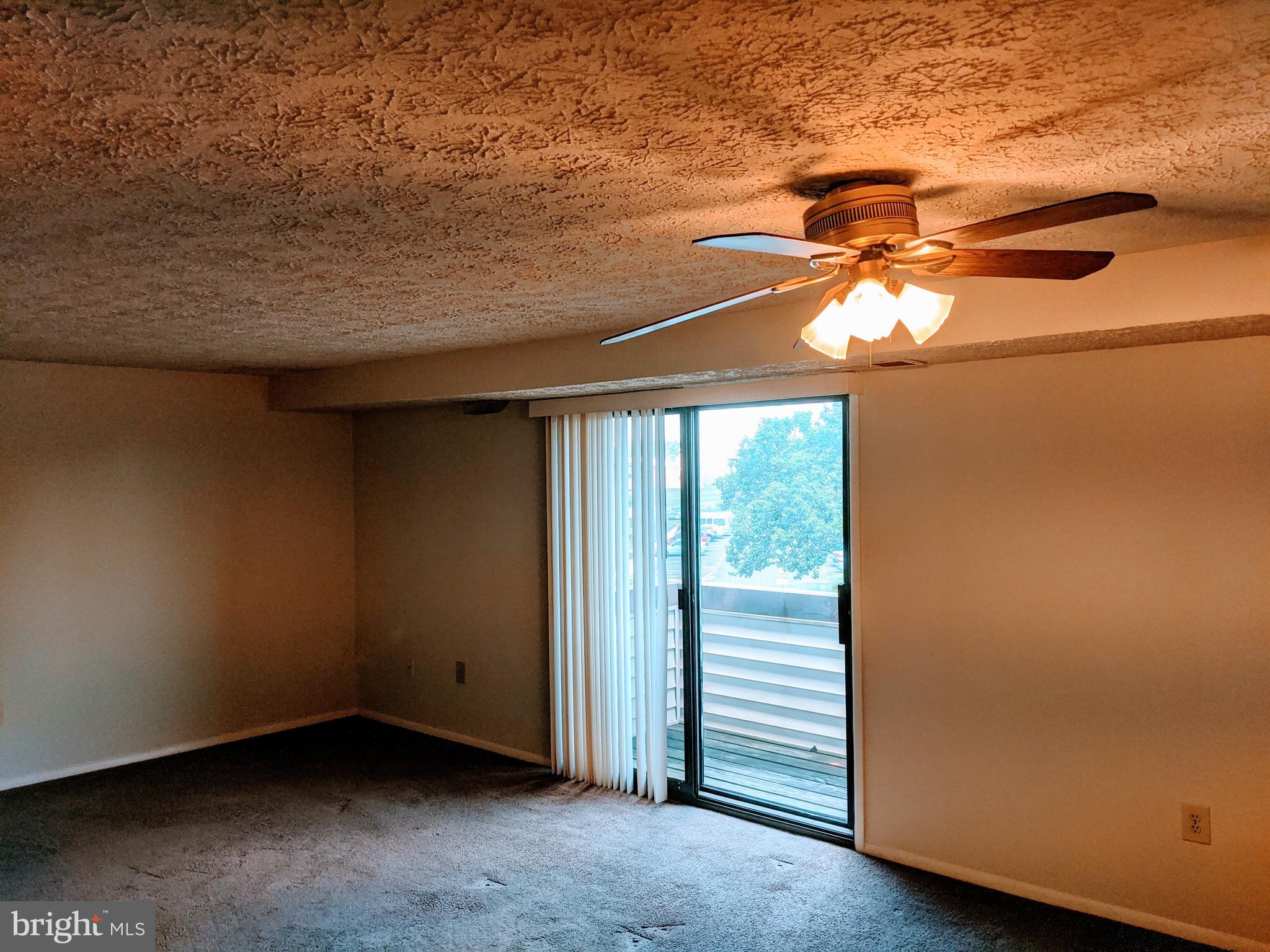 995 Heather Ridge Drive, Unit 4J Frederick, MD 21702 - Photo 7 of 21 Living room / dining area w/ ceiling fan