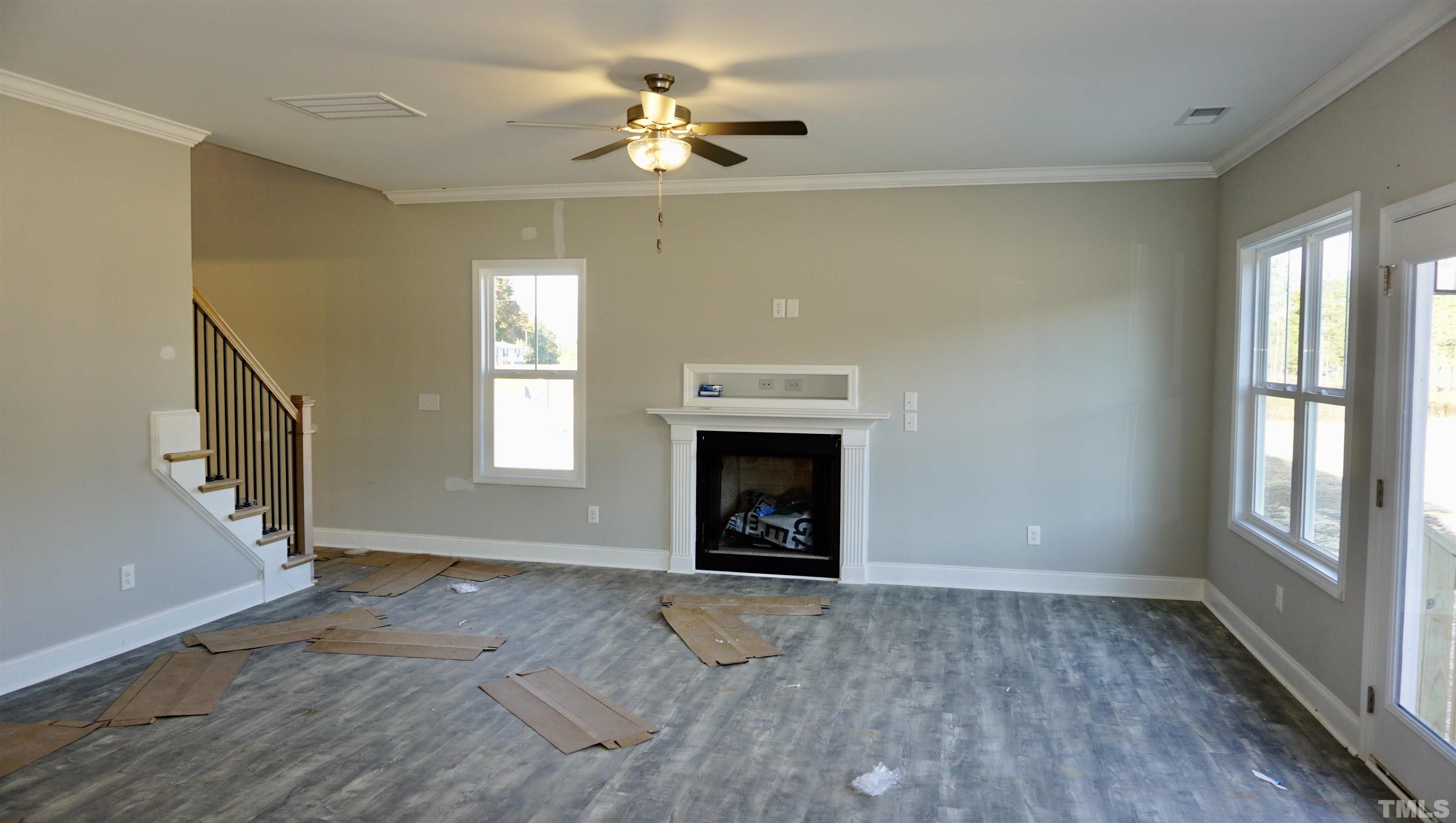 10519 West Old Spring Hope Road Spring Hope, NC 27882 - Photo 12 of 30 wooden floor fireplace and windows in an empty room