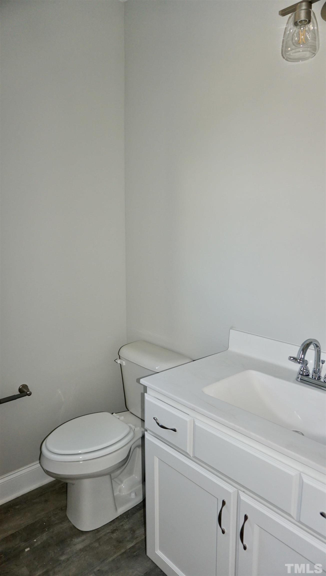10519 West Old Spring Hope Road Spring Hope, NC 27882 - Photo 19 of 30 a white toilet sitting next to a bathroom sink