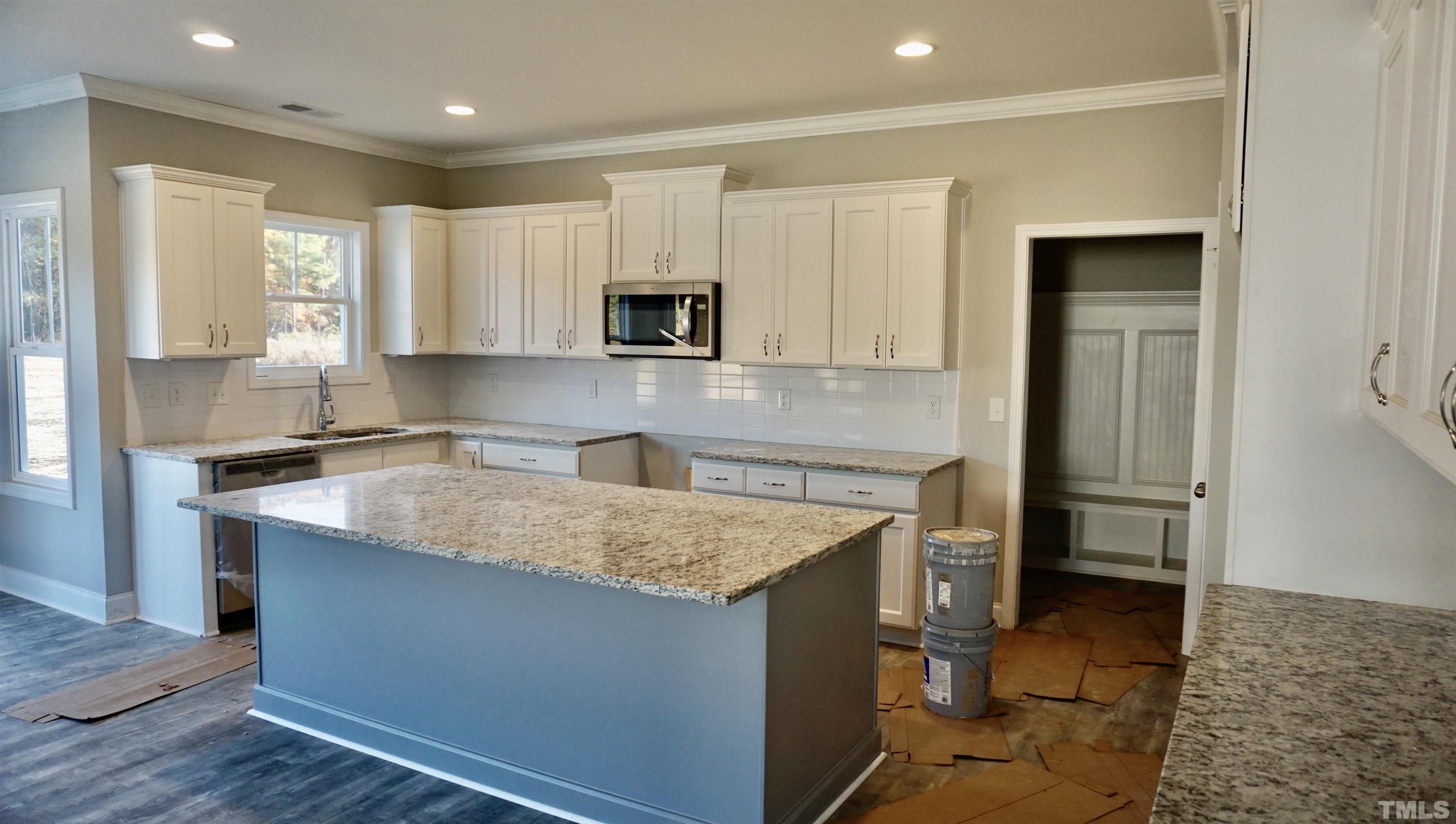 10519 West Old Spring Hope Road Spring Hope, NC 27882 - Photo 29 of 30 a kitchen with kitchen island granite countertop a sink stove and refrigerator