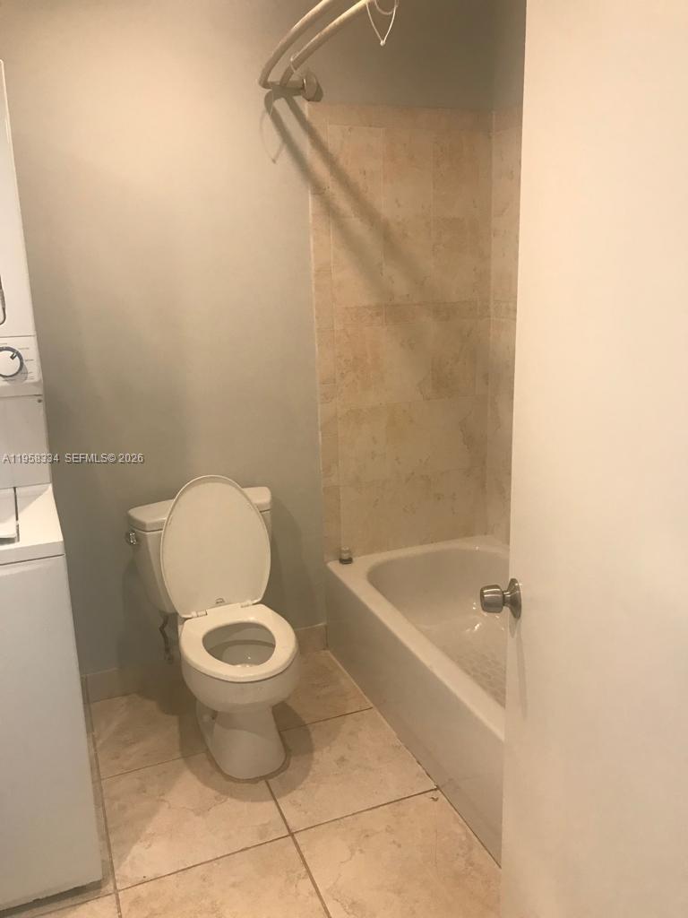 7570 Southwest 82nd Street, Unit F209 Miami, FL 33143 - Photo 12 of 13 a white toilet sitting next to a bath tub