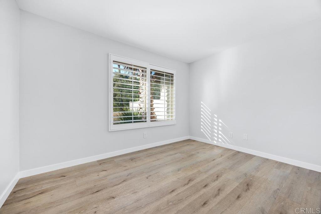 1741 Charleston Lane Encinitas, CA 92024 - Photo 13 of 18 a view of an empty room with wooden floor and a window