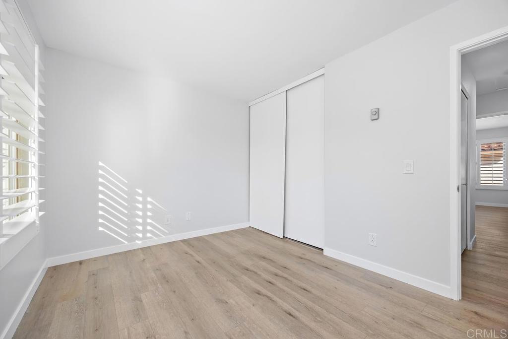 1741 Charleston Lane Encinitas, CA 92024 - Photo 14 of 18 an empty room with wooden floor and windows