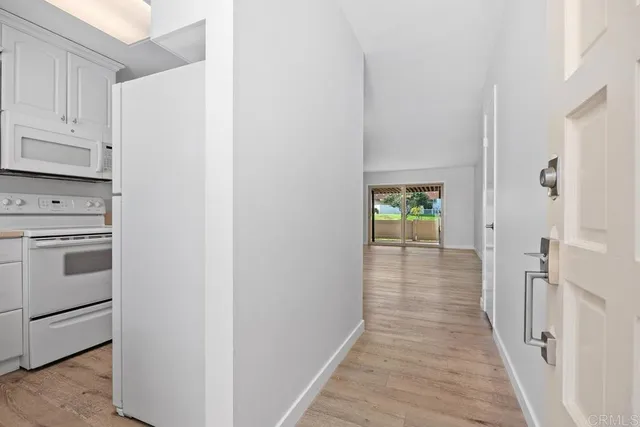 a view of a hallway with washer and dryer
