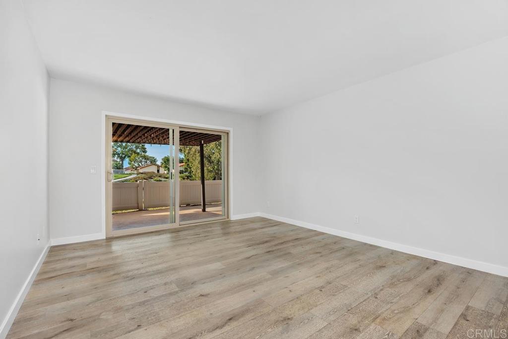1741 Charleston Lane Encinitas, CA 92024 - Photo 5 of 18 a view of an empty room with wooden floor and a window