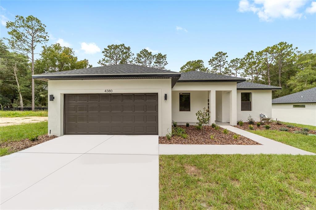 4380 Southwest 159th Court Ocala, FL 34481 - Photo 1 of 52 a front view of a house with garden