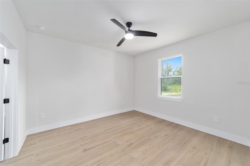 4380 Southwest 159th Court Ocala, FL 34481 - Photo 17 of 52 wooden floor in an empty room with a window