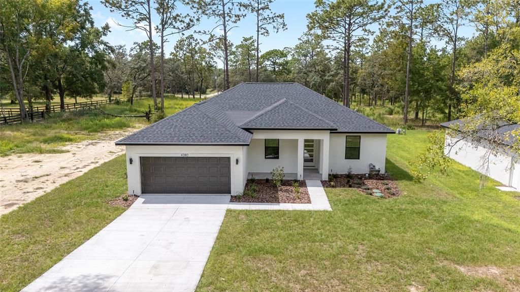 4380 Southwest 159th Court Ocala, FL 34481 - Photo 40 of 52 a front view of a house with garden