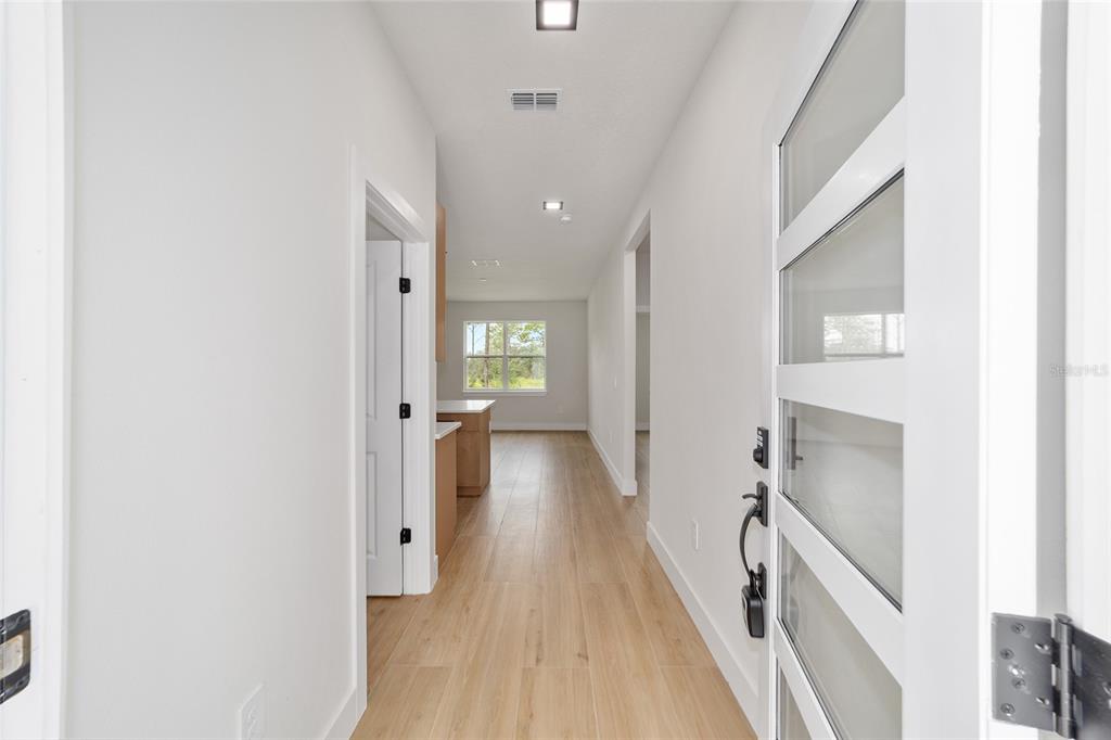 4380 Southwest 159th Court Ocala, FL 34481 - Photo 4 of 52 a view of a hallway with wooden floor and staircase