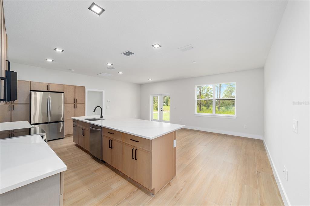4380 Southwest 159th Court Ocala, FL 34481 - Photo 5 of 52 a kitchen with stainless steel appliances a sink a stove a refrigerator and cabinets