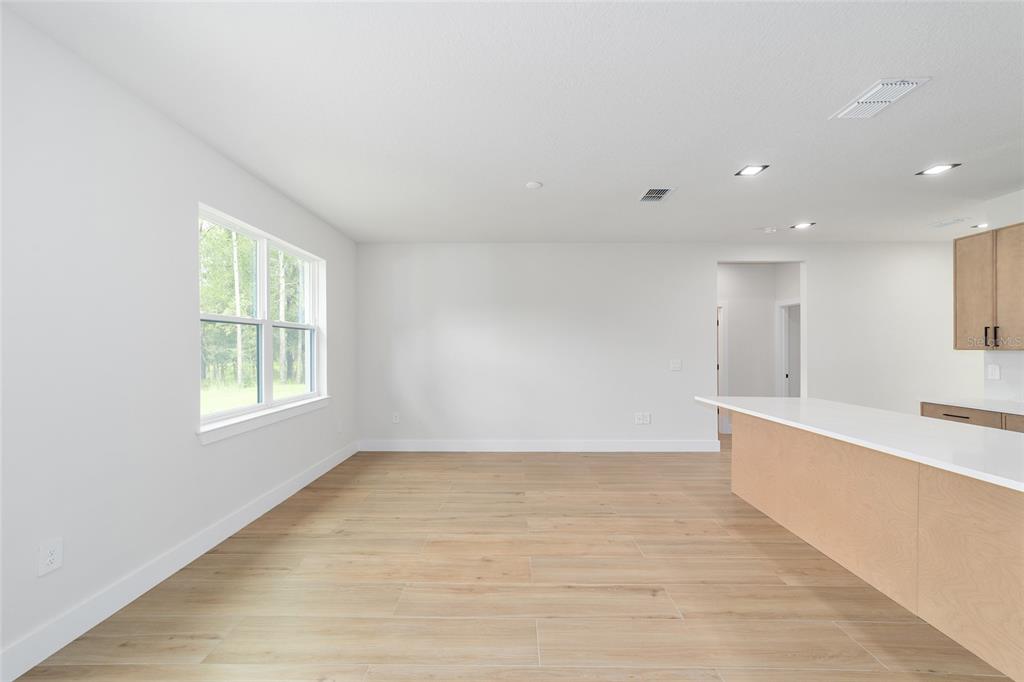 4380 Southwest 159th Court Ocala, FL 34481 - Photo 10 of 52 a view of an empty room with wooden floor and a window