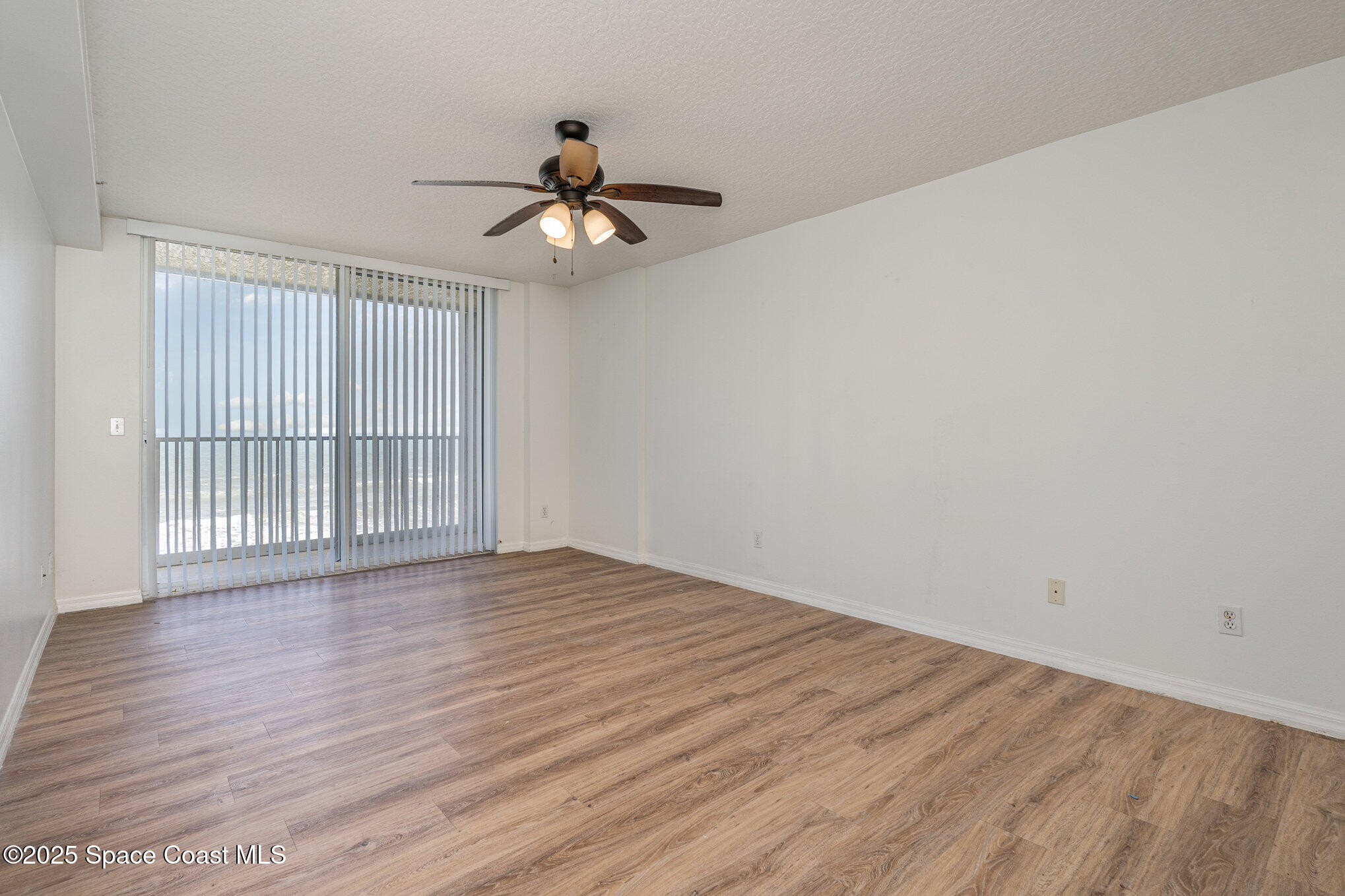 1575 North Hwy A1A, Unit 613 Indialantic, FL 32903 - Photo 11 of 23 a view of an empty room with wooden floor and a window