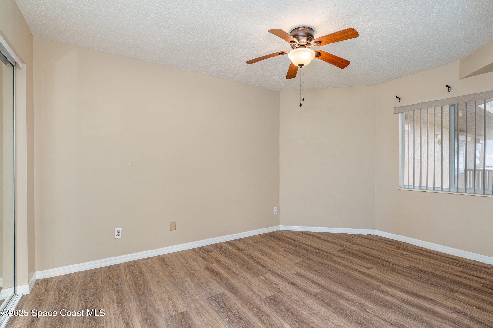 1575 North Hwy A1A, Unit 613 Indialantic, FL 32903 - Photo 16 of 23 a view of an empty room with window and a ceiling fan