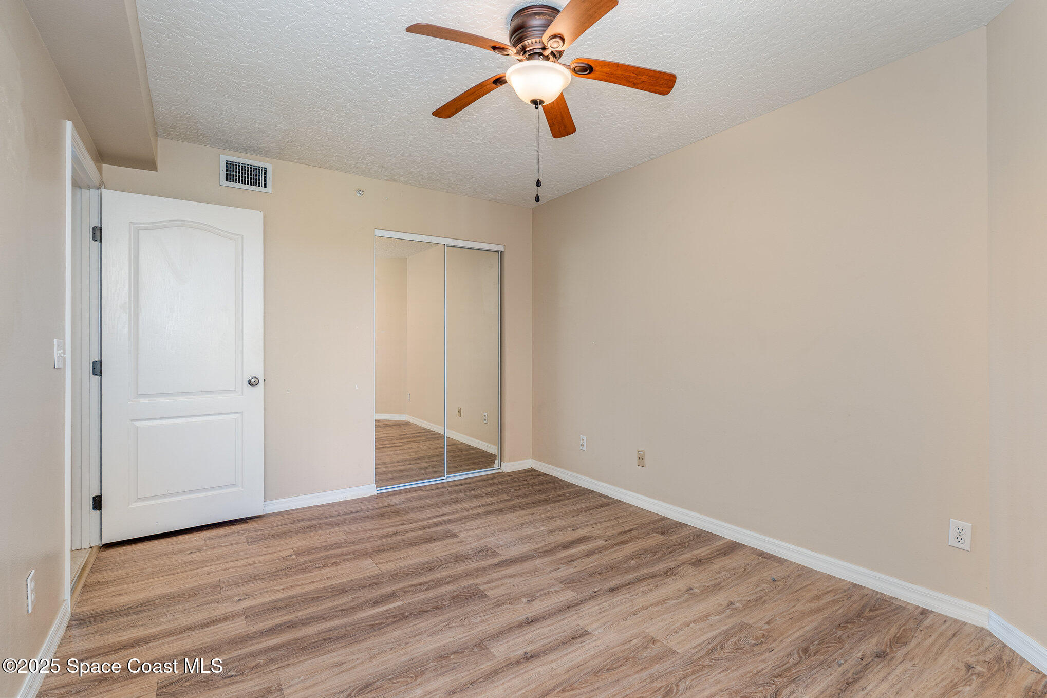 1575 North Hwy A1A, Unit 613 Indialantic, FL 32903 - Photo 17 of 23 a view of an empty room with window and wooden floor