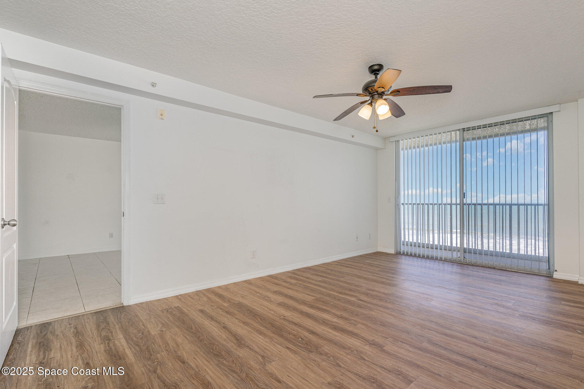 1575 North Hwy A1A, Unit 613 Indialantic, FL 32903 - Photo 10 of 23 a view of empty room with wooden floor and fan