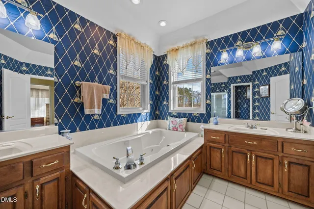 a bathroom with a granite countertop sink a mirror and shower