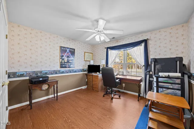 a view of hallway with stairs and wooden floor