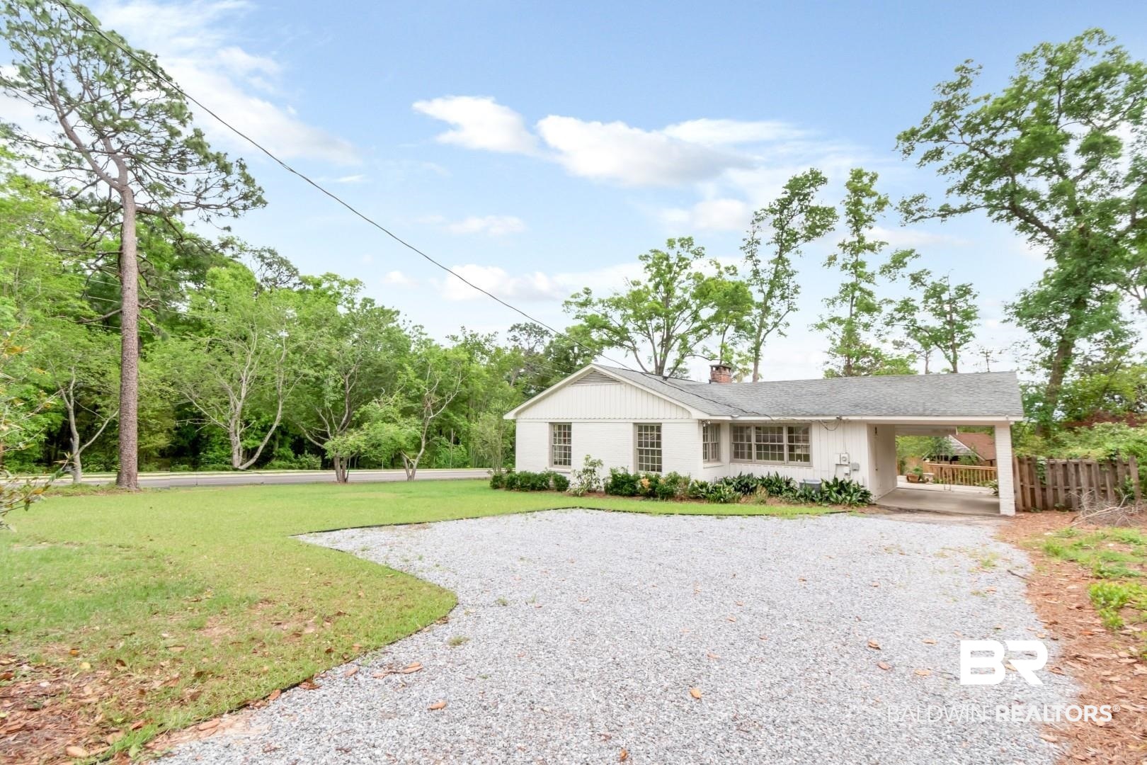4 Turnout Lane Mobile, AL 36608 - Photo 45 of 53 View of front of house featuring driveway, a carport, a front lawn, and a chimney