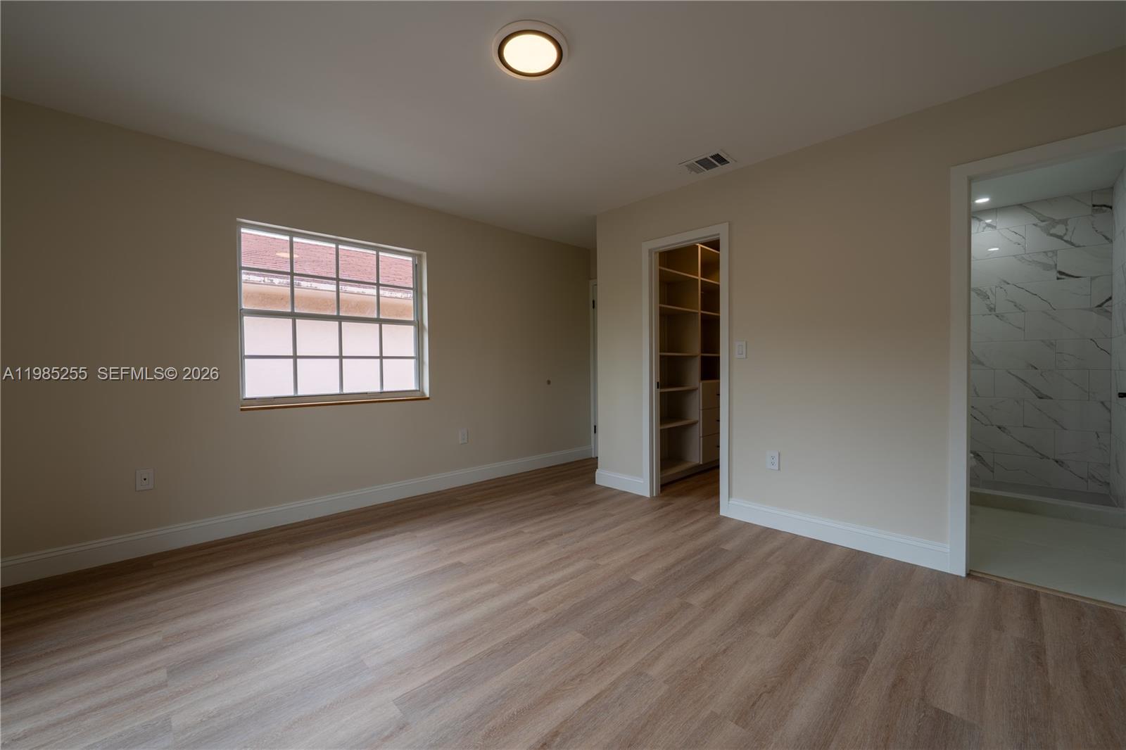370 Flagami Boulevard Miami, FL 33144 - Photo 16 of 67 an empty room with wooden floor and windows