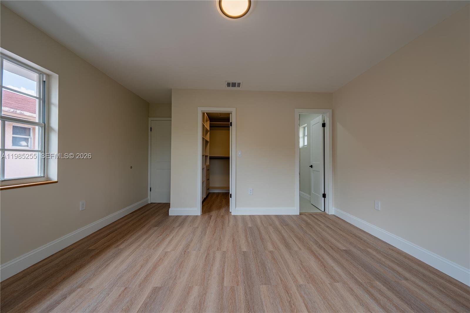 370 Flagami Boulevard Miami, FL 33144 - Photo 17 of 67 wooden floor in an empty room with a window