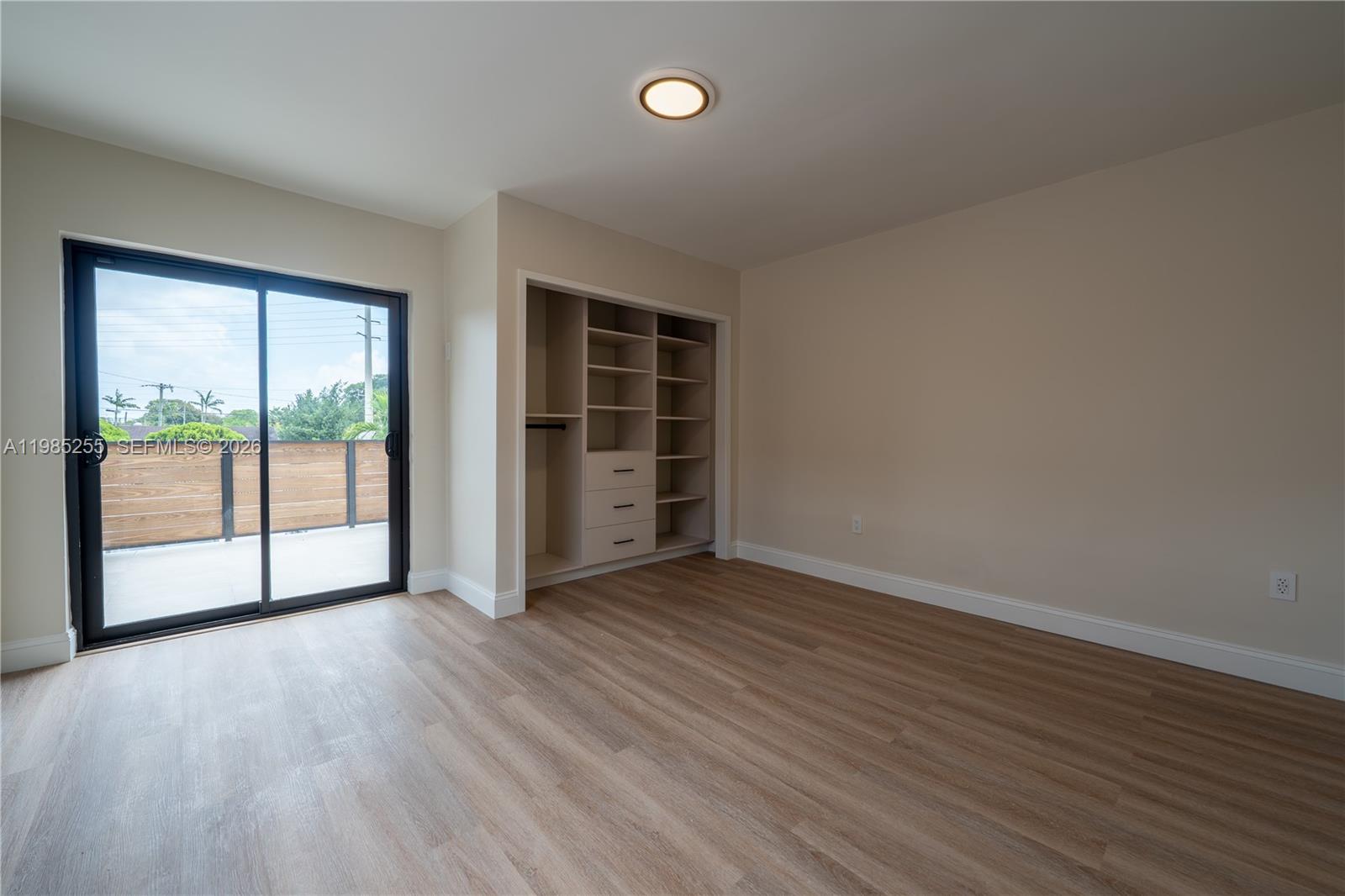 370 Flagami Boulevard Miami, FL 33144 - Photo 28 of 67 an empty room with wooden floor and windows