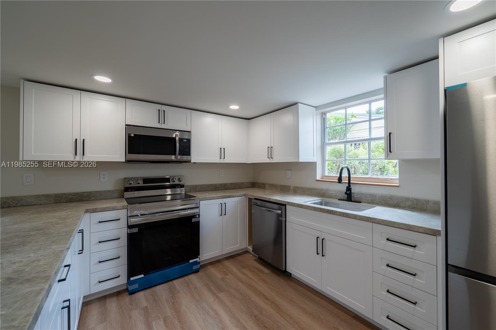 370 Flagami Boulevard Miami, FL 33144 - Photo 3 of 67 a kitchen with a sink stove and microwave
