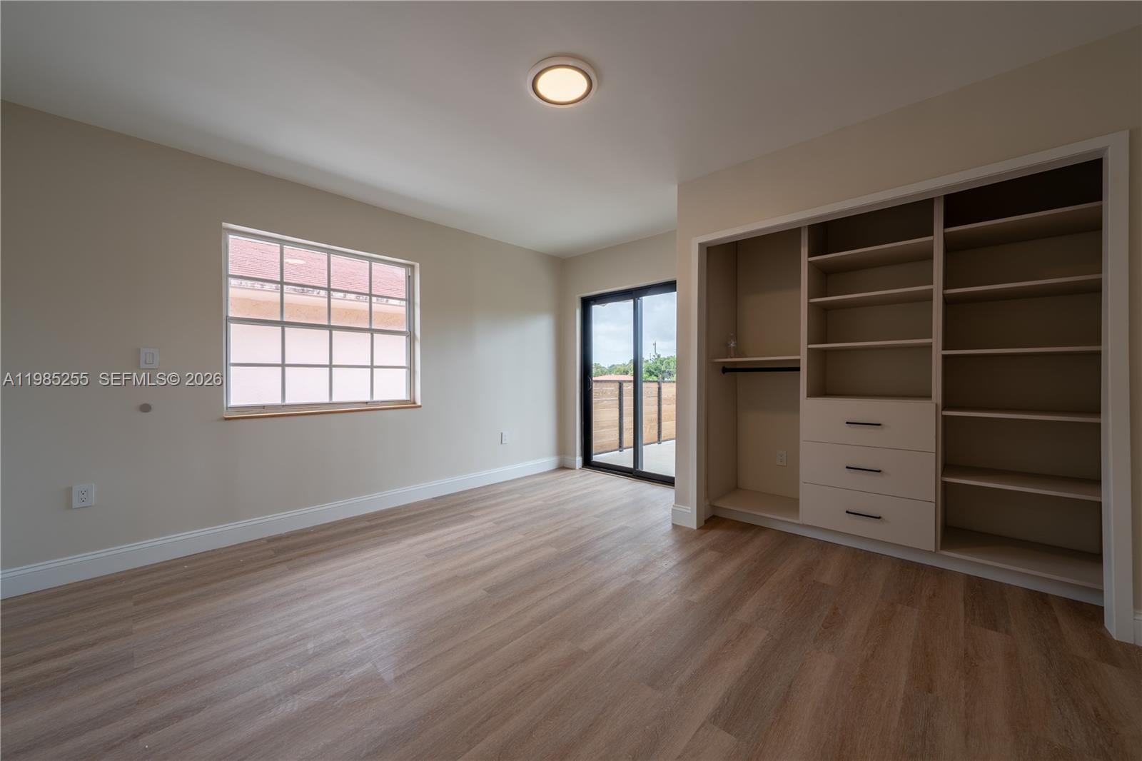 370 Flagami Boulevard Miami, FL 33144 - Photo 36 of 67 wooden floor in an empty room with a window