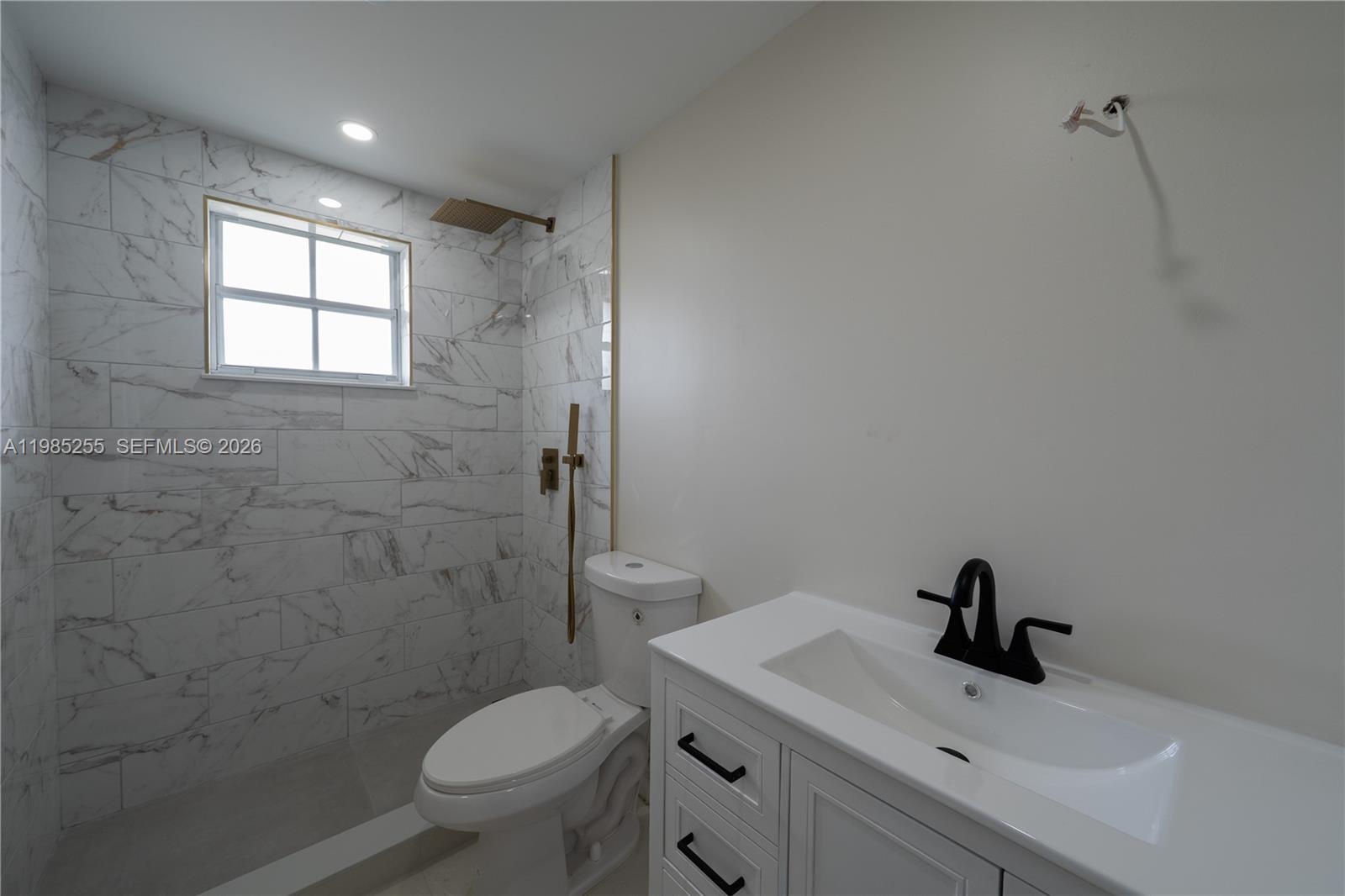 370 Flagami Boulevard Miami, FL 33144 - Photo 43 of 57 a bathroom with a toilet sink and mirror