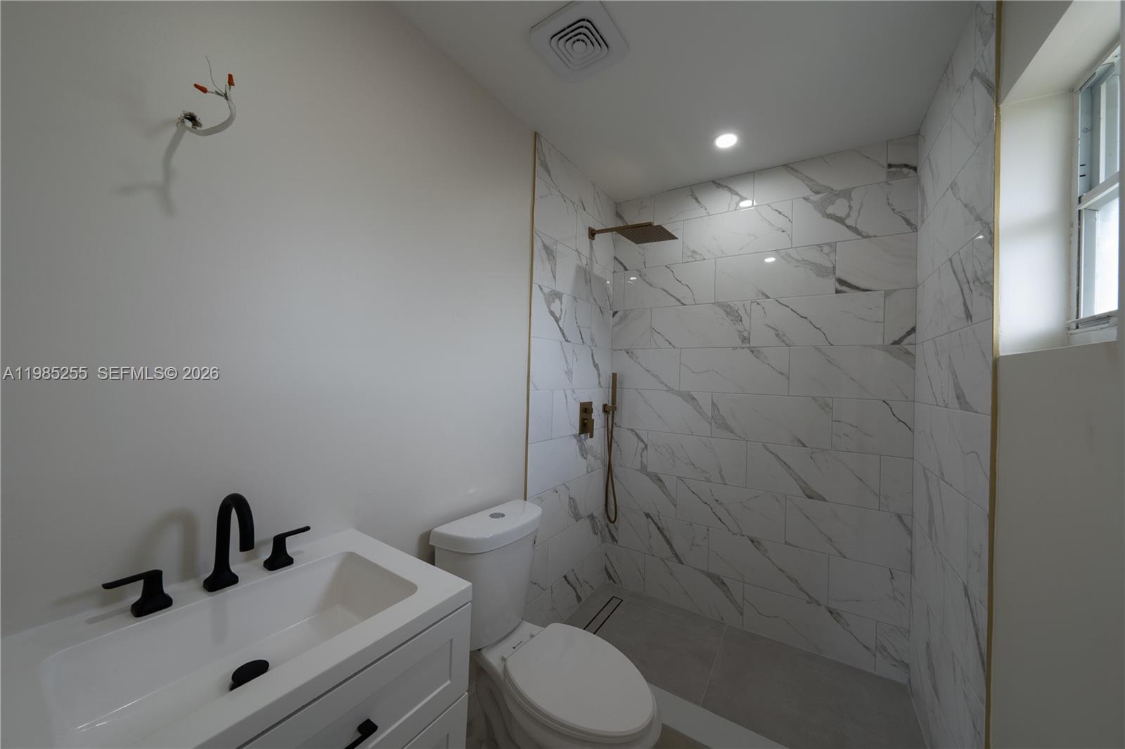 370 Flagami Boulevard Miami, FL 33144 - Photo 48 of 57 a bathroom with a sink mirror vanity and toilet
