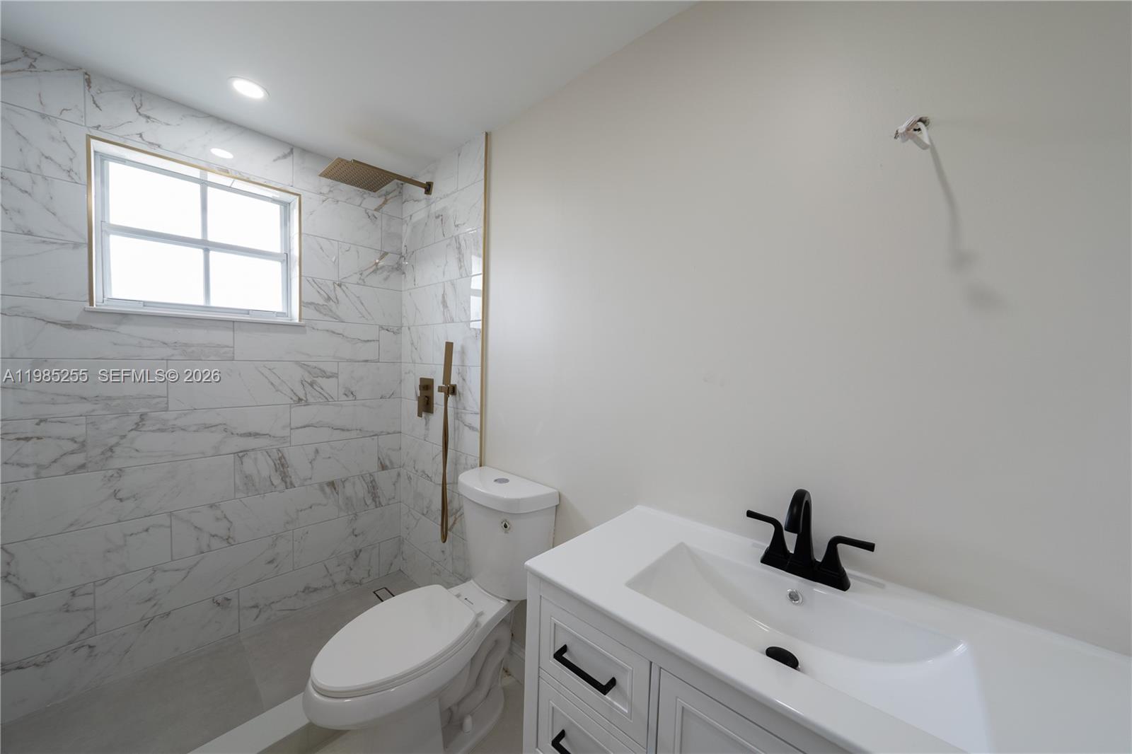 370 Flagami Boulevard Miami, FL 33144 - Photo 50 of 67 a bathroom with a toilet sink a mirror and shower