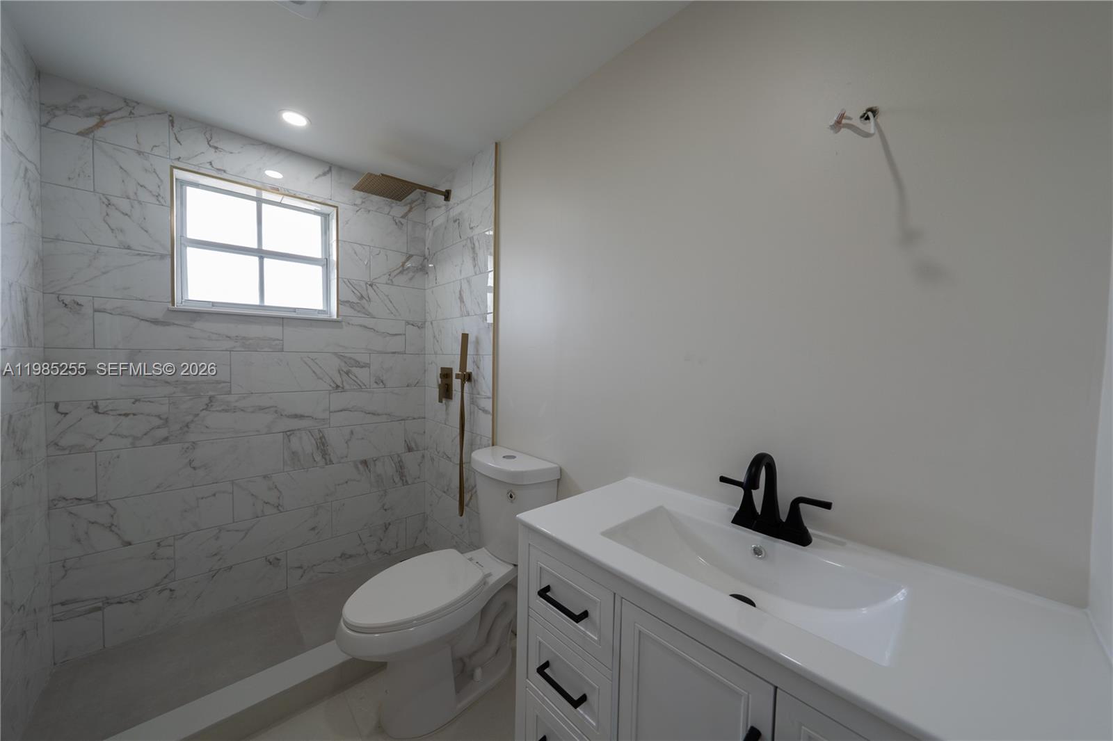 370 Flagami Boulevard Miami, FL 33144 - Photo 59 of 67 a bathroom with a toilet sink and mirror