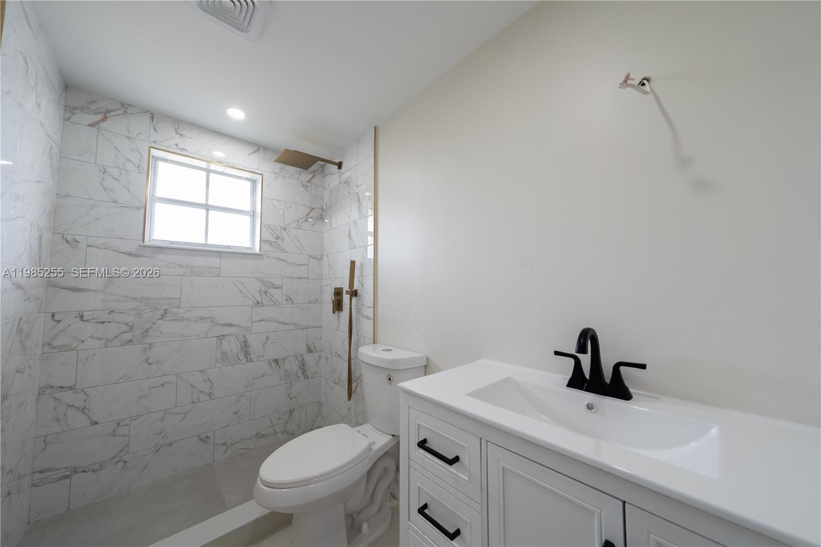 370 Flagami Boulevard Miami, FL 33144 - Photo 66 of 67 a bathroom with a sink a toilet and a mirror