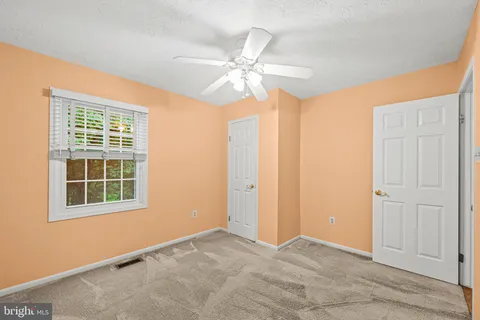 a bed room with a bed and a chair