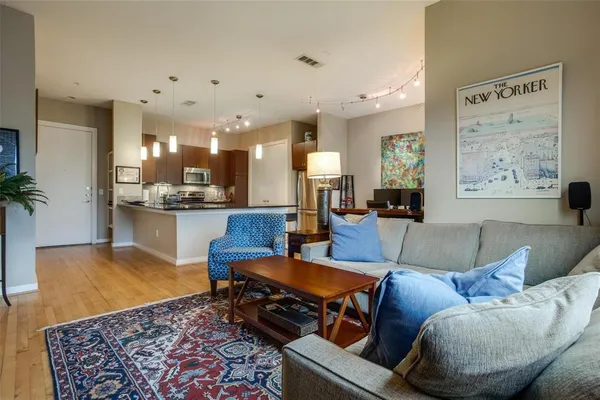 a living room with furniture and kitchen view