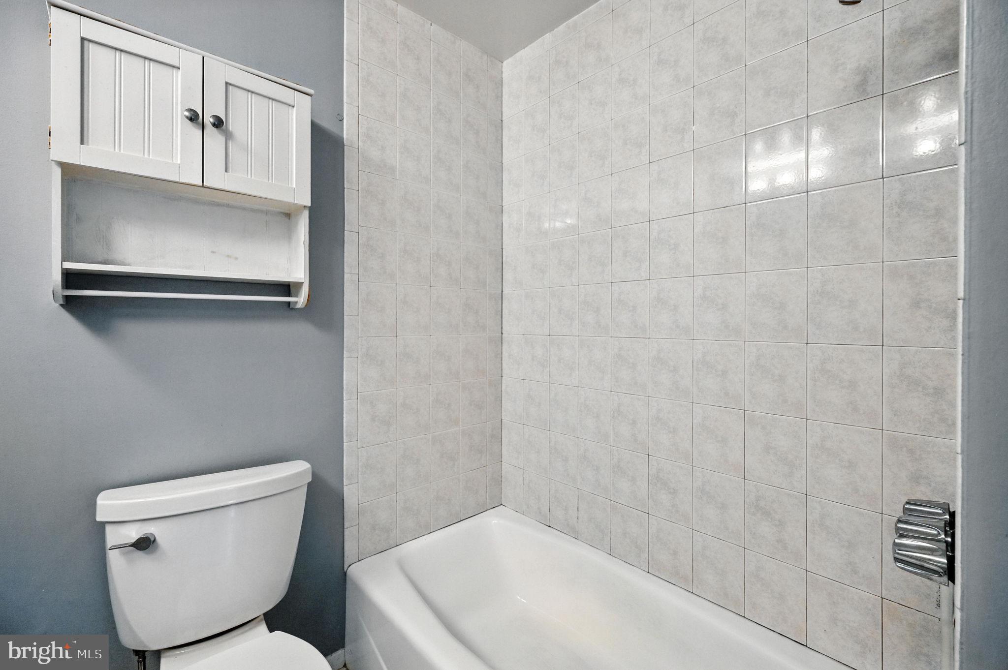 9301 Montpelier Drive Laurel, MD 20708 - Photo 11 of 23 a bathroom with a toilet and a sink