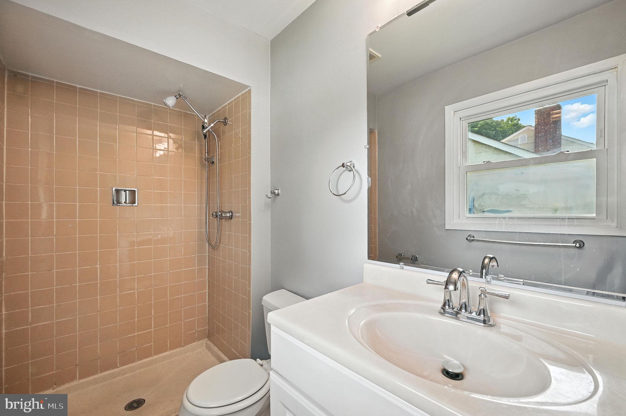 9301 Montpelier Drive Laurel, MD 20708 - Photo 17 of 23 a bathroom with a sink toilet and shower