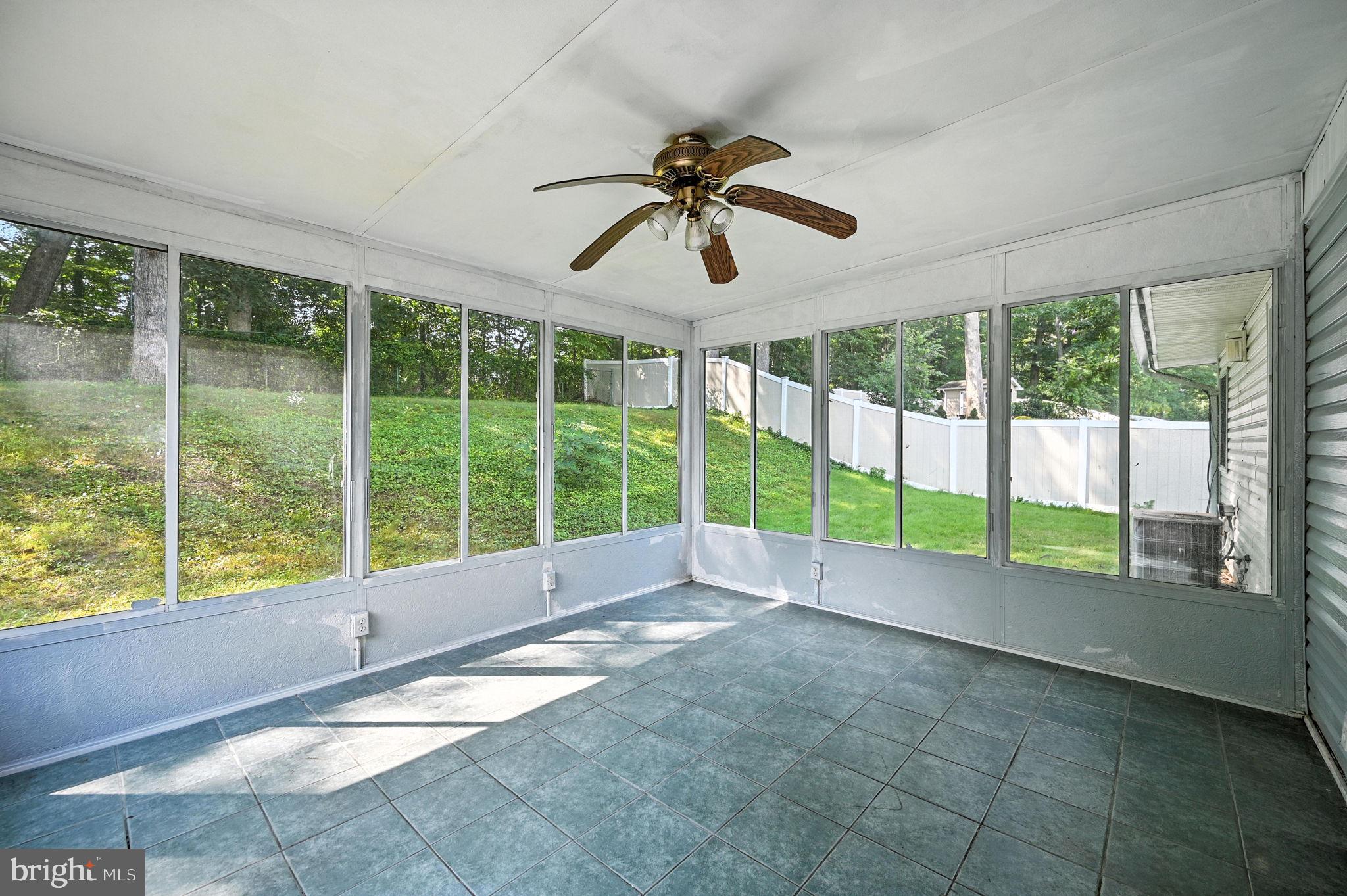 9301 Montpelier Drive Laurel, MD 20708 - Photo 21 of 23 a view of an empty room with wooden floor and a floor to ceiling window