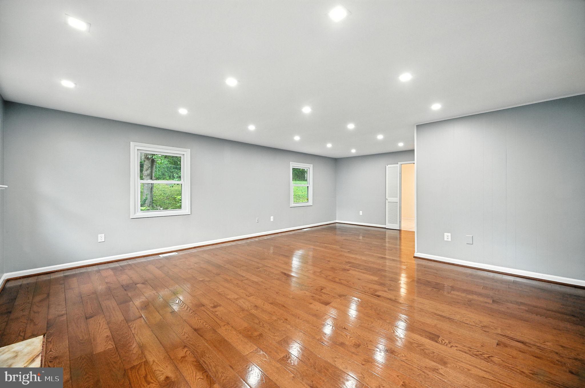 9301 Montpelier Drive Laurel, MD 20708 - Photo 5 of 23 an empty room with wooden floor and windows