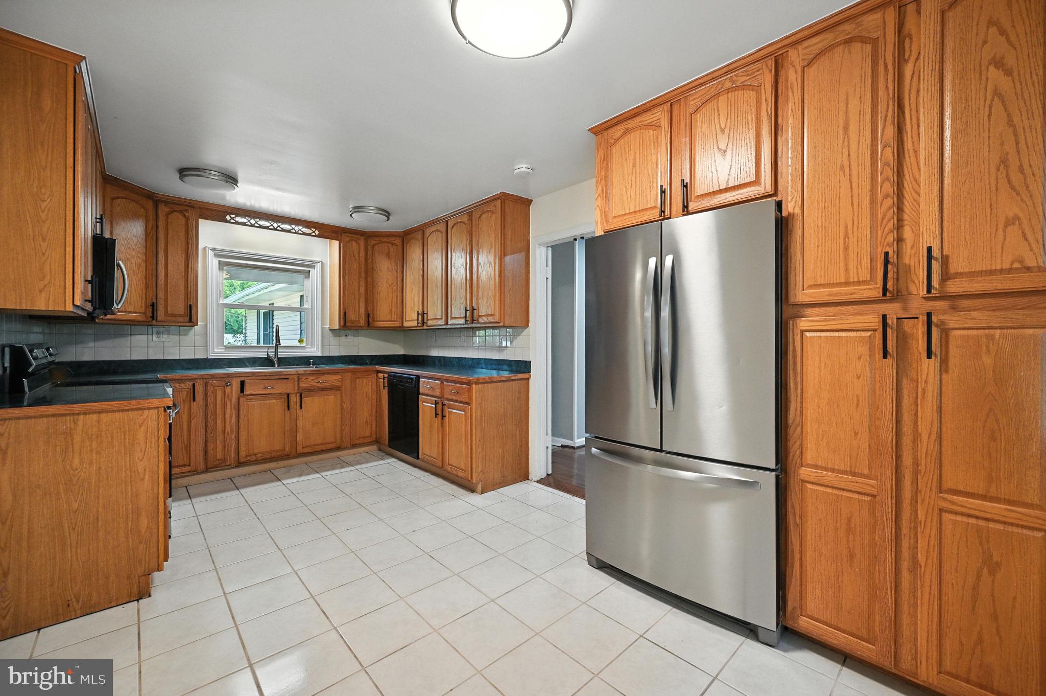 9301 Montpelier Drive Laurel, MD 20708 - Photo 6 of 23 a kitchen with stainless steel appliances granite countertop a refrigerator sink and cabinets